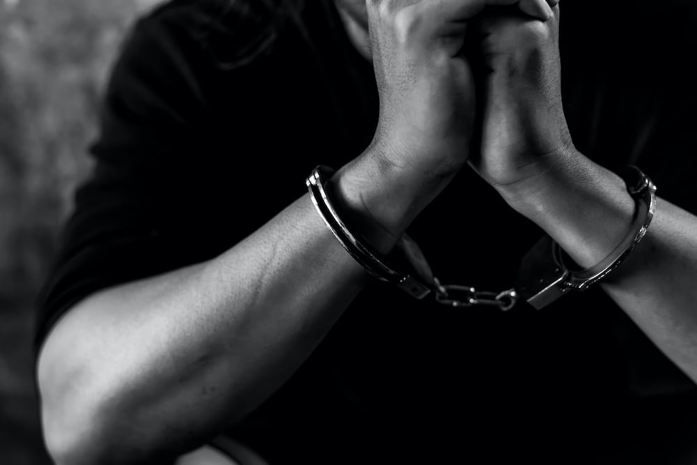 person in handcuffs